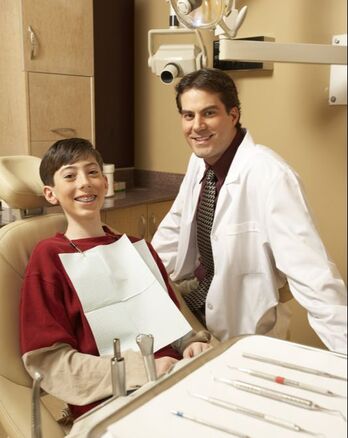 Pediatric Dentist with Happy Patient